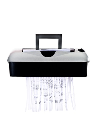 Office paper shredder at work - isolated on white backgroundの写真素材