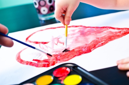 Child drawing red heart for Motherの写真素材