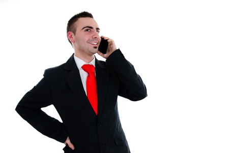 Young businessman talking with his touchscreen phoneの写真素材