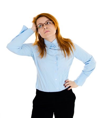 Young redheaded businesswoman thinking and wonderingの写真素材