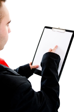 Young busiessman holding out a blank clipboard with space for text  Pointing on something with his fingerの写真素材