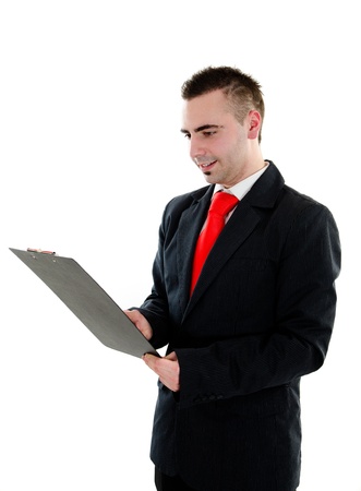 Young busiessman holding and writing in black office clipboard - isolated on white backgroundの写真素材