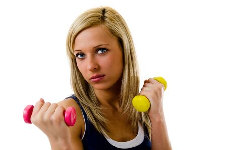 Blonde pretty fitness girl working out with dumbbellsの写真素材