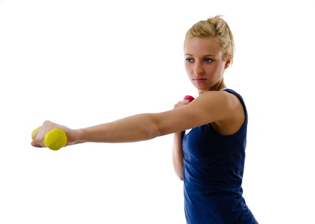 Portrait of young woman with dumbbellsの写真素材