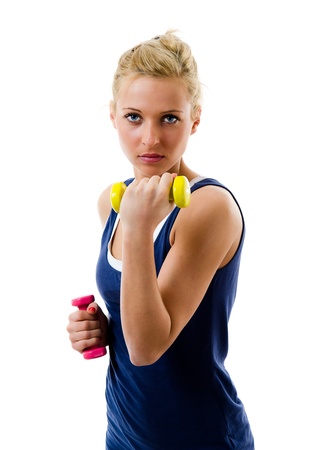 Blonde girl using dumbbells to train her bicepsの写真素材