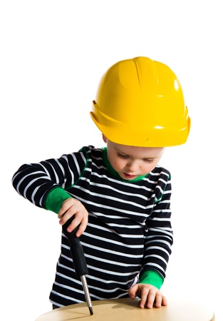 Little baby boy playing with screwdriver - isolated on white backgroundの写真素材