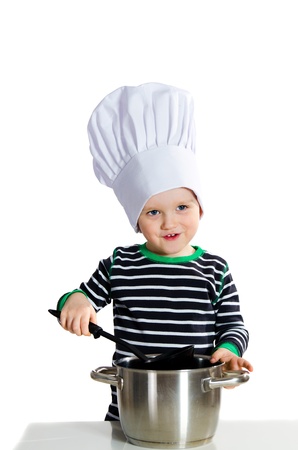 Smiling little baby boy in cook hat duging cooking - isolated on white backgroundの写真素材
