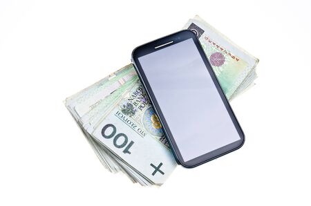 Modern touchscreen cell phone on stack of Polish moneyの写真素材