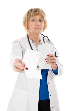 Middle aged woman doctor standing and giving medical recipes - isolated on white backgroundの写真素材