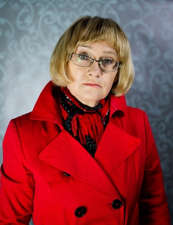 Mature blond woman in red coat の写真素材