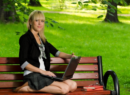 Girl using a laptop studying for the exam in the parkの写真素材