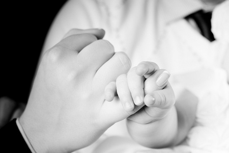 baby holding a finger of mother - black and whiteの写真素材