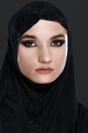 Beautiful muslim arabic woman on grey backgroundの写真素材