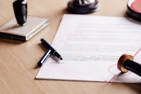 Notary pen lying on testament. Notary public working accesoriesの写真素材