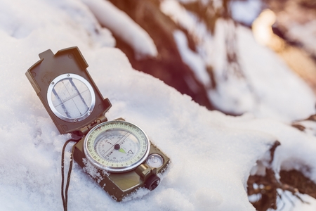 Compass instrument on snow. Winter mountain trip conceptの写真素材