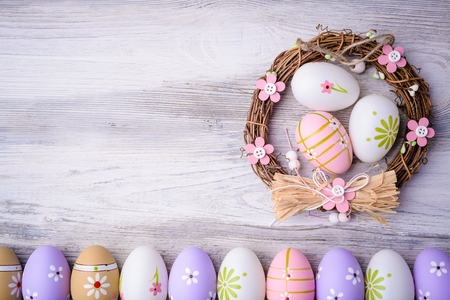 Painted colorful Easter eggs and nest on grey wooden background Top view. Flat lay. Easter concept. Happy Easter !の写真素材