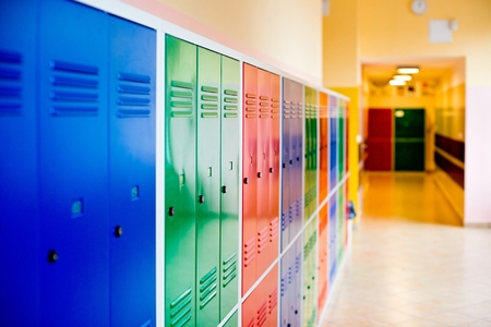 Colorful metal lockers installed in the hallway of the school.