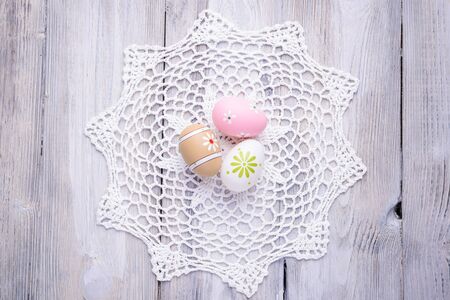 Colorful Easter eggs with white serviette on old cracked wooden background.  Easter concept. Happy Easter !の写真素材