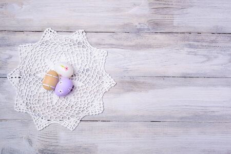 Colorful Easter eggs with white serviette on old cracked wooden background. Copy space. Easter concept. Happy Easter !の写真素材