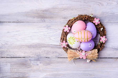 Colorful Easter eggs in nest on old cracked wooden background. Copyspace.  Easter concept. Happy Easter !の写真素材