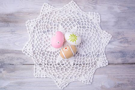 Colorful Easter eggs with white serviette on old cracked wooden background.  Easter concept. Happy Easter !の写真素材