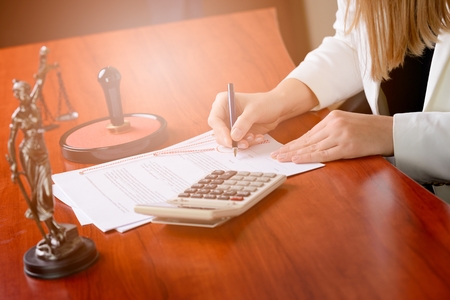 Woman Notary Public signing the notary acti n her office. Law officeの写真素材