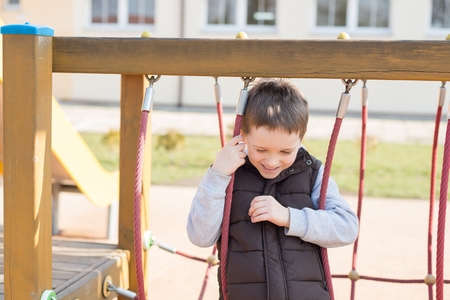 Happy games - pretty happy boy on the playground in the schoolの写真素材