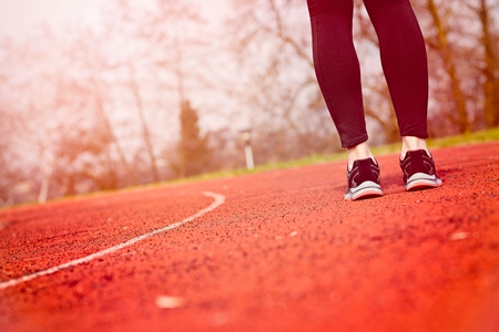 Woman run training outdoors. Young lady doing exercises and ready to start running. Health and sport...
