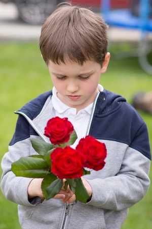 Boy with a bouquet of roses for his mother on "Mother's Day"の写真素材