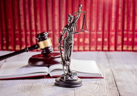 Symbols of law in court  library. Judge gavel, goddess of justice Themis and legal codes. Law conceptの写真素材