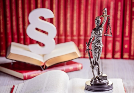 Symbols of law in court library. Wooden paragraph, goddess of justice Themis and legal codes. Law...