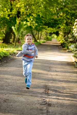 Children's Day.  Little boy running in the park.の写真素材
