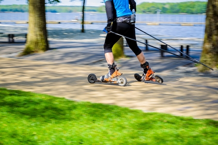 Man cross-country skiing with roller ski - motion blur
