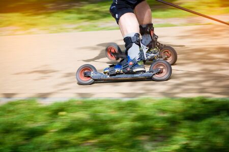 Man cross-country skiing with roller ski - motion blur