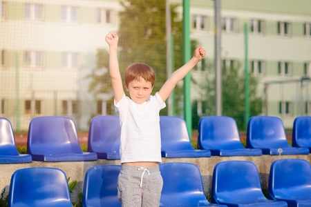 Little football fan happy after a goal for his favorite teamの写真素材