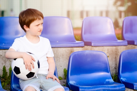 Small football fans disappointed after the loss goal by his favorite teamの写真素材