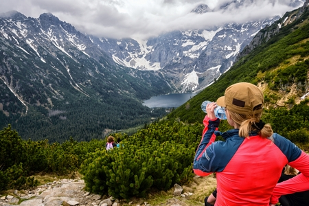 Woman drinking mineral bottled water on mountain track in Polish Tatra Mountains. Tatra National Parkの写真素材
