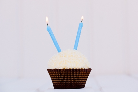 Birthday's cake - muffin with two candles. Happy birthday !の写真素材