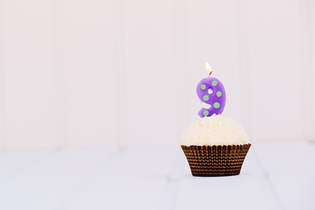 Birthday's cake - muffin with a candle in the shape of a figure 9. Happy birthday !の写真素材