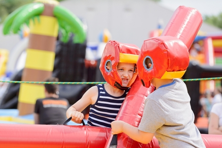 Kids playing - fighting in colorful playgroundの写真素材
