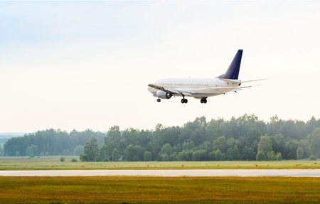 Landing or taking off passenger airplane at airportの写真素材
