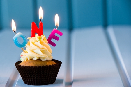 Birthday's cake - cupcake with a candles for 1 - first birthday . Happy birthday !の写真素材
