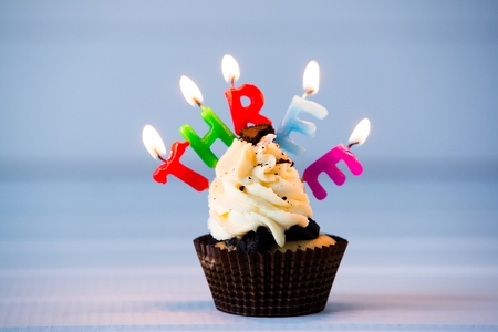 Birthday's cake - cupcake with a candles for 3 - third birthday . Happy birthday !の写真素材