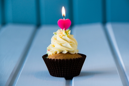 Birthday's cake - cupcake with a heart shaped candles for 1 - first birthday or valentine's day.の写真素材