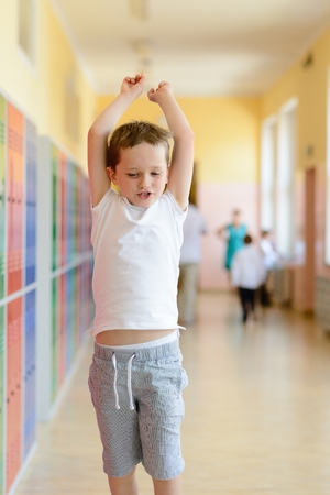 Happy 7 years old schoolboy running out of school. End of school.の写真素材