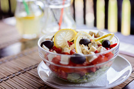 Tasty Greek salad in a bowl in restaurantの写真素材