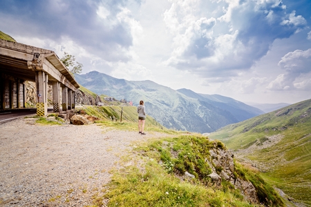 Young woman on cliff's edge in Romanian Carpathian mountains near Transfagarasan Roadの写真素材