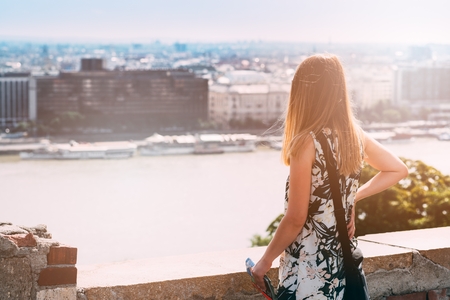 Young woman looking on city - Budapest from viewpointの写真素材