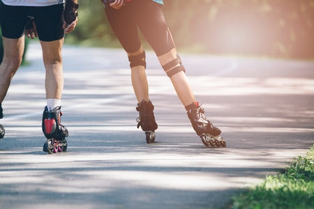 Rollerblading on asphalt road. Summer sunny day
