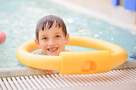 Seven years old boy learning to swim at the pool. Swimming schoolの写真素材